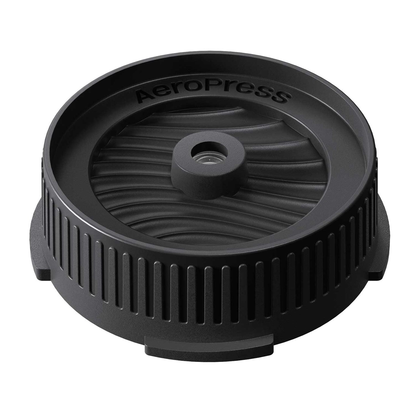Black AeroPress coffee brewing flow control cap component on a white background