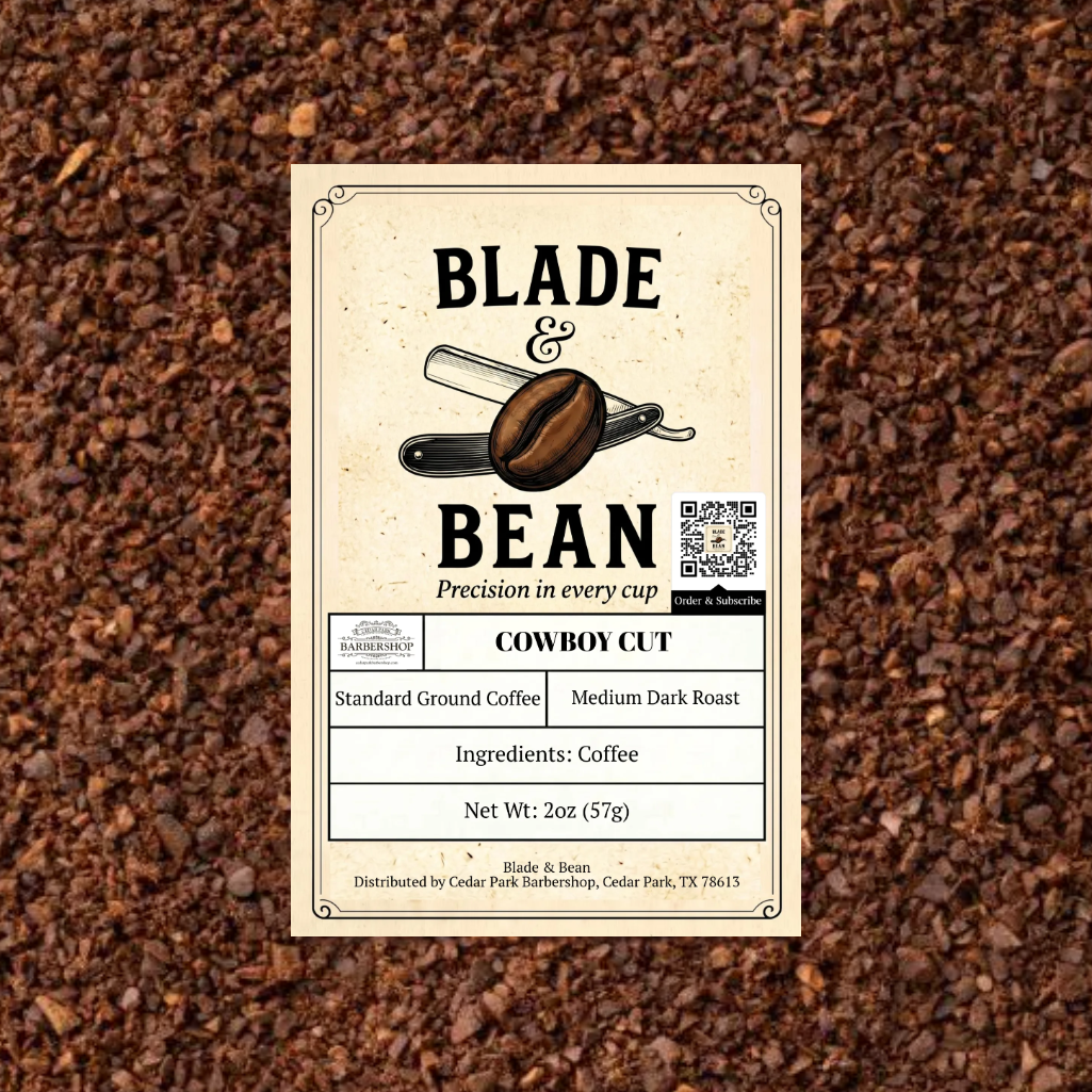 A rectangular product label for Blade & Bean Cowboy Cut coffee sits centered on a textured background of dark brown coffee beans. The label is cream-colored with black text and an illustration of a coffee bean and scale.