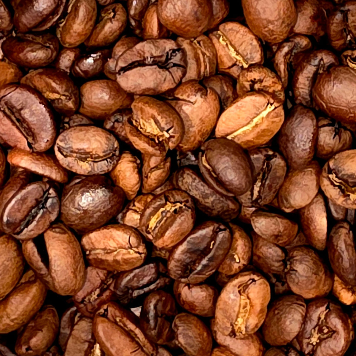 A close-up, top-down view of roasted coffee beans filling the entire frame, showing their rich dark brown color and characteristic crevices.