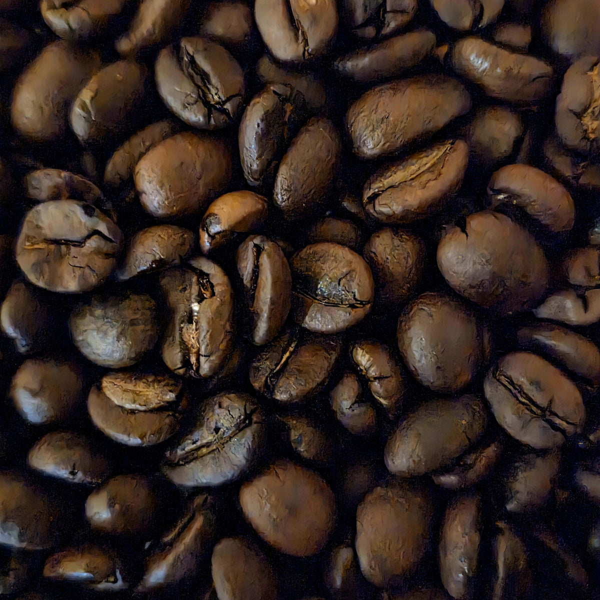 A close-up, top-down view of roasted coffee beans filling the frame, showing their glossy dark brown surfaces and characteristic creases.