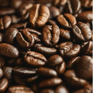 Close-up of African coffee beans roasted to a medium dark roast in a brown craft paper bag