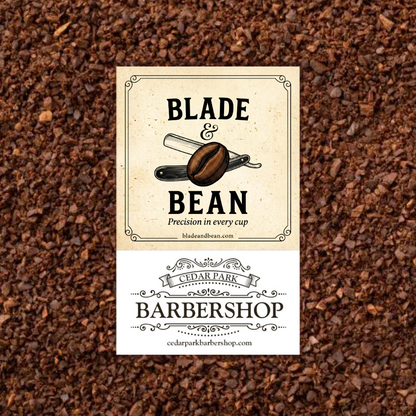 Two business cards on a textured brown surface, one for 'Blade & Bean' and one for 'Cedar Park Barbershop'.