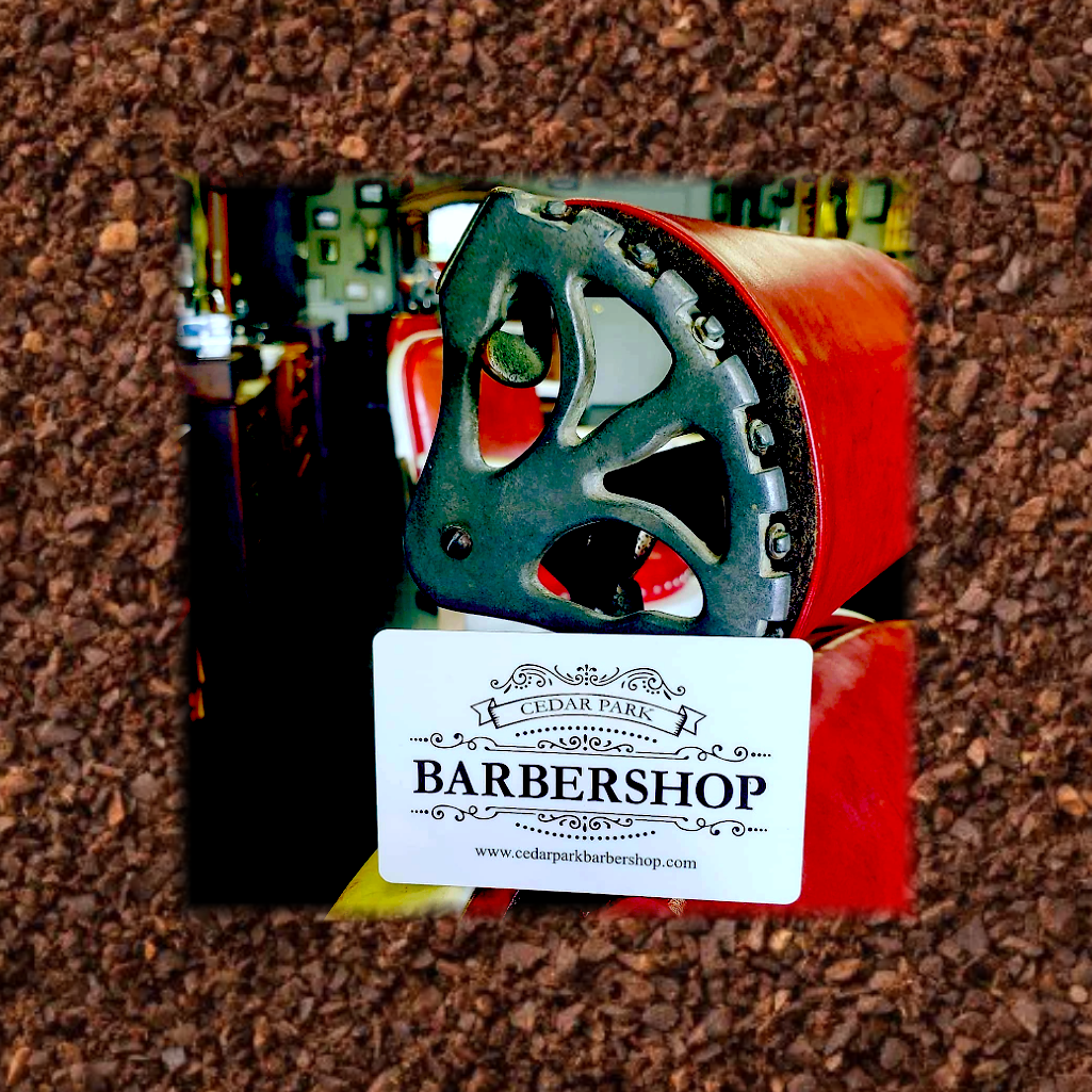 Red and black barber shop tool with a GIFT card on a brown textured background