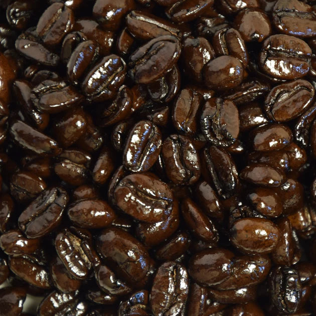 Close-up of dark French roasted coffee beans that are oily