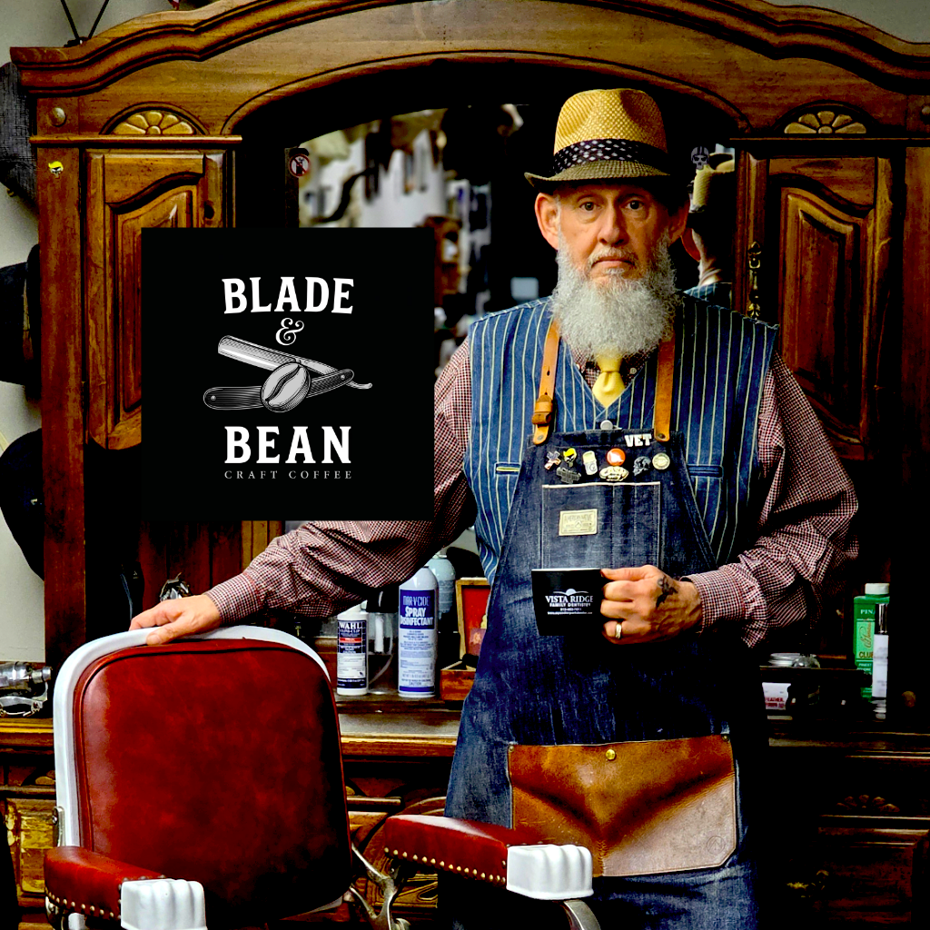 Barber in a barbershop holding a coffee cup with 'Vista Ridge Family Dentistry' branding.