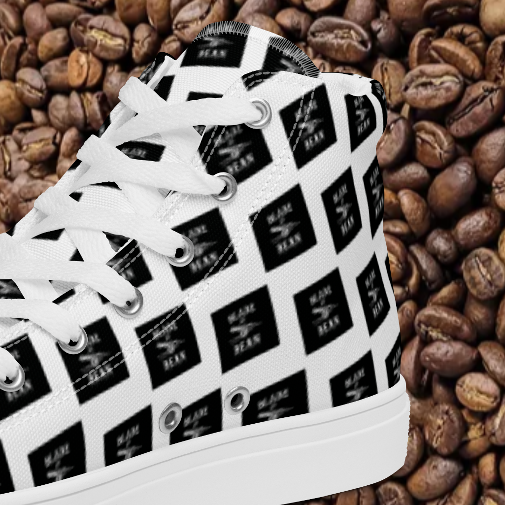 White sneaker with black pattern on a bed of coffee beans
