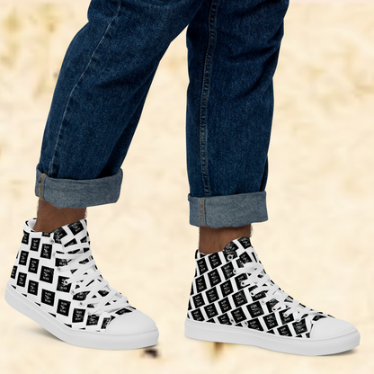 White high-top sneakers with black pattern worn with rolled-up jeans on a beige background
