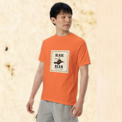 Person wearing an orange t-shirt with 'Blade & Bean' logo on a beige background
