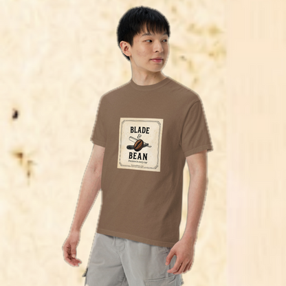 Person wearing a brown t-shirt with 'Blade & Bean' logo on a beige background