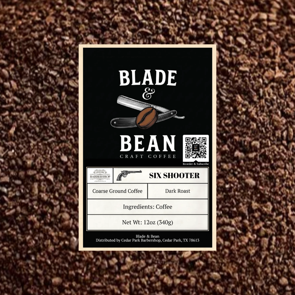 A rectangular coffee label for Blade & Bean Craft Coffee, featuring a black background with white text and an illustration of a coffee bean and folding knife, set against a background of loose coffee beans. The label details the 'Six Shooter' dark roast coffee.