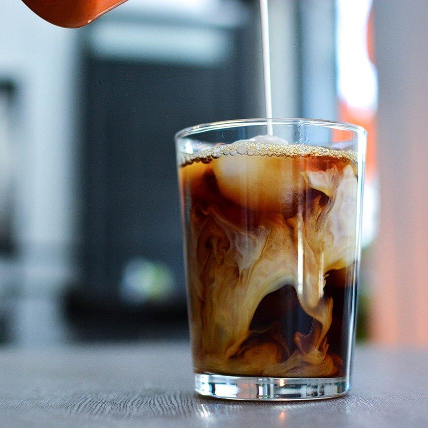Glass of iced coffee with a blurred background