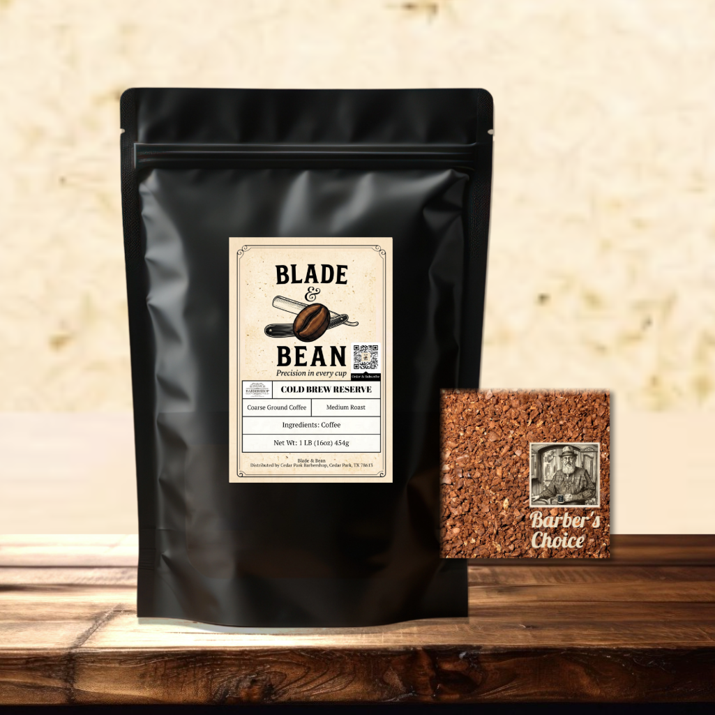 A black stand-up coffee pouch labeled Blade & Bean Cold Brew Reserve stands on a wooden surface against a textured beige wall, with a small square of the coarse ground coffee labeled Barber's Choice beside it.