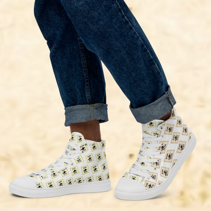White high-top sneakers with black and yellow pattern worn with rolled-up jeans on a beige background