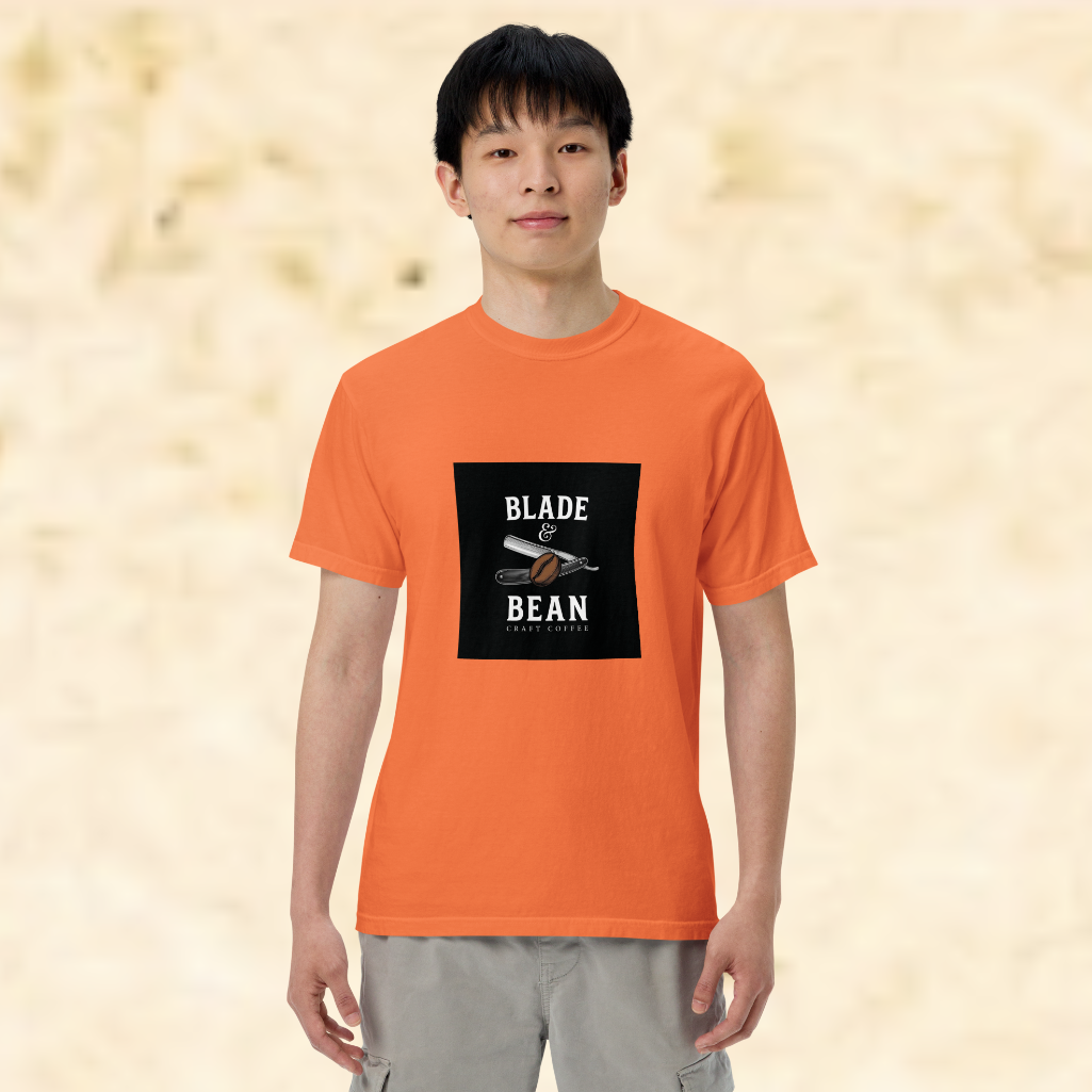 Person wearing an orange t-shirt with 'Blade & Bean' logo on a beige background