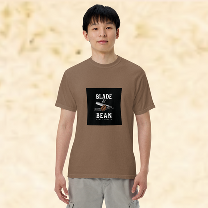 Person wearing a brown t-shirt with 'Blade & Bean' logo on a beige background