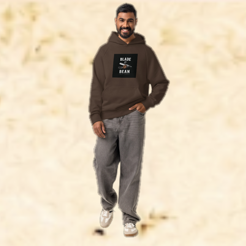 Man wearing a brown hoodie with a logo on a beige background