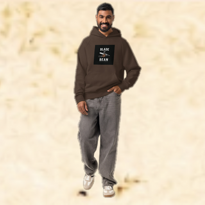 Man wearing a brown hoodie with a logo on a beige background