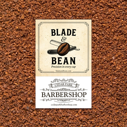 A rectangular bar label for Blade & Bean Barbershop is centered over a textured background of brown coffee beans. The label has a cream top half with an illustration of a coffee bean and razor, and a white bottom half with the Cedar Park Barbershop name and website.