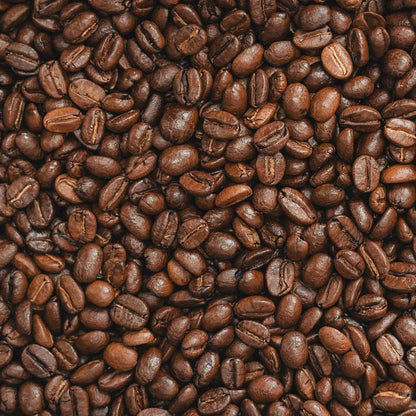 Close-up of a pile of coffee beans roasted to a med dark for Blade & Beans MAX Caff Blend