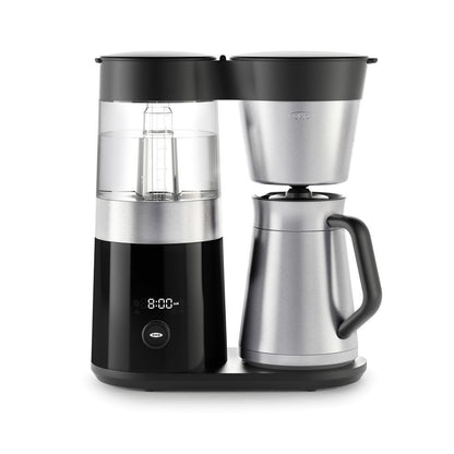 Black and silver coffee maker with digital display on a white background