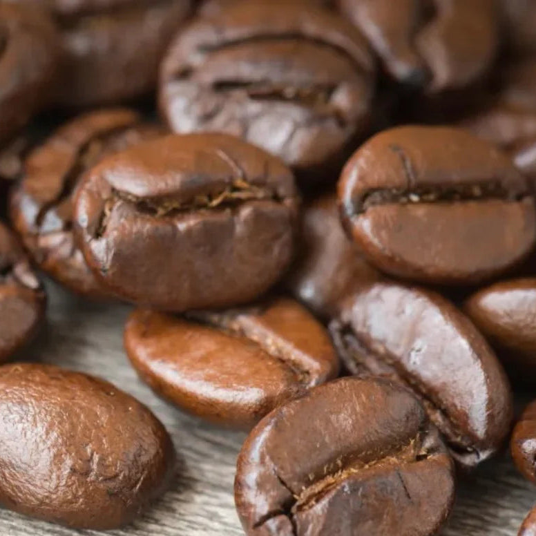 Close-up of medium roasted Peru coffee beans on a wooden surface