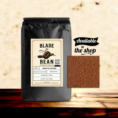 Coffee bag labeled 'Blade & Bean' with ground coffee sample on a wooden surface.