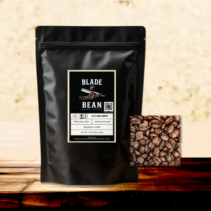 Black coffee bag with 'Blade & Bean' label and coffee beans on a wooden surface