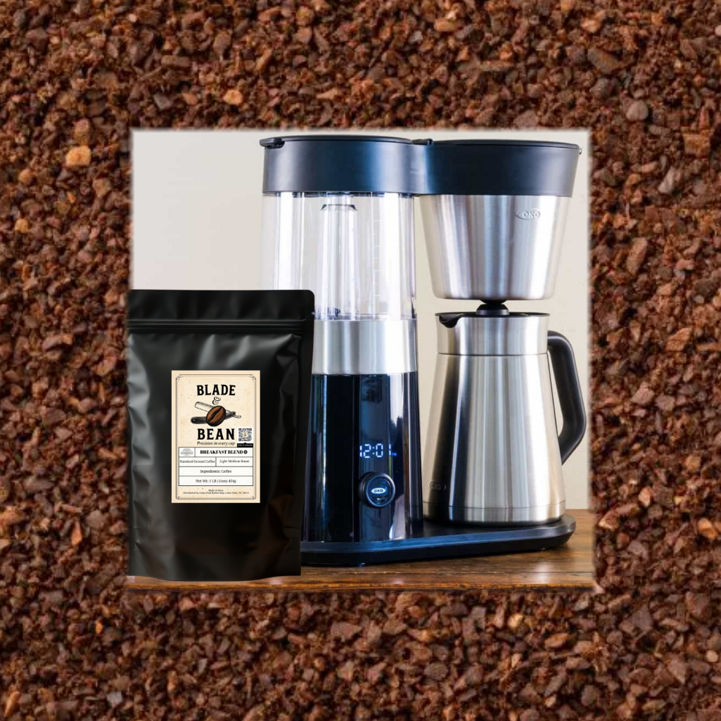 Coffee maker with a bag of coffee labeled 'Blade & Bean' on a bed of ground coffee.