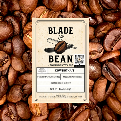 A centered cream-colored product label for Blade & Bean Cowboy Cut coffee, placed over a background filled with roasted coffee beans. The label includes the brand name, product name, roast details, and a small QR code.