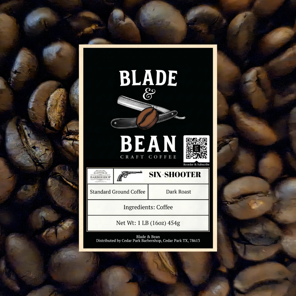 A coffee label for Blade & Bean Craft Coffee's 'Six Shooter' dark roast coffee, centered over a background of roasted coffee beans. The label is black with white text and a vintage revolver illustration.