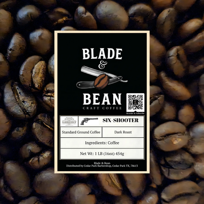 A coffee label for Blade & Bean Craft Coffee's 'Six Shooter' dark roast coffee, centered over a background of roasted coffee beans. The label is black with white text and a vintage revolver illustration.