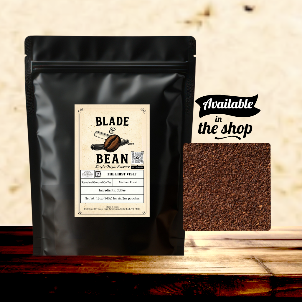 Black coffee packaging with 'Blade & Bean' label and ground coffee sample on a wooden surface.