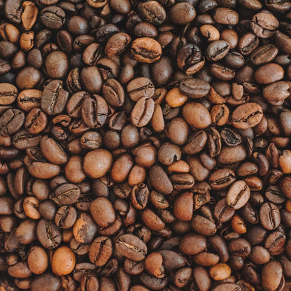 Close-up of roasted Tanzania coffee beans with a focus on texture and color variation.