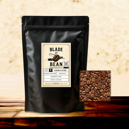 Black coffee bag with 'Blade Bean' label and a container of coffee beans on a wooden surface.