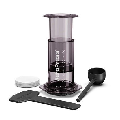 AeroPress coffee maker with components on a white background